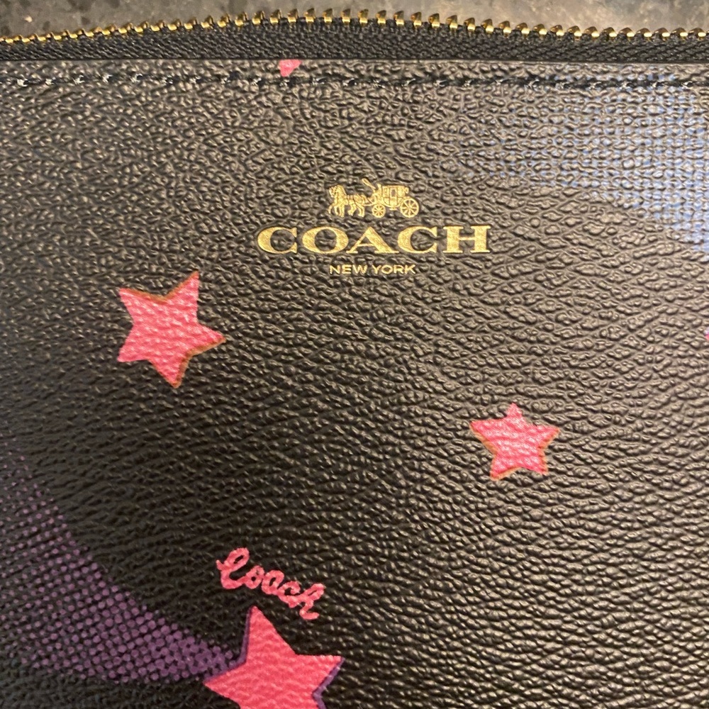 Never used, brand new Coach “disco star” limited edition wristlet.